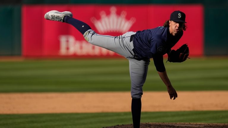 Seattle Mariners' Logan Gilbert follows through on a pitch to...