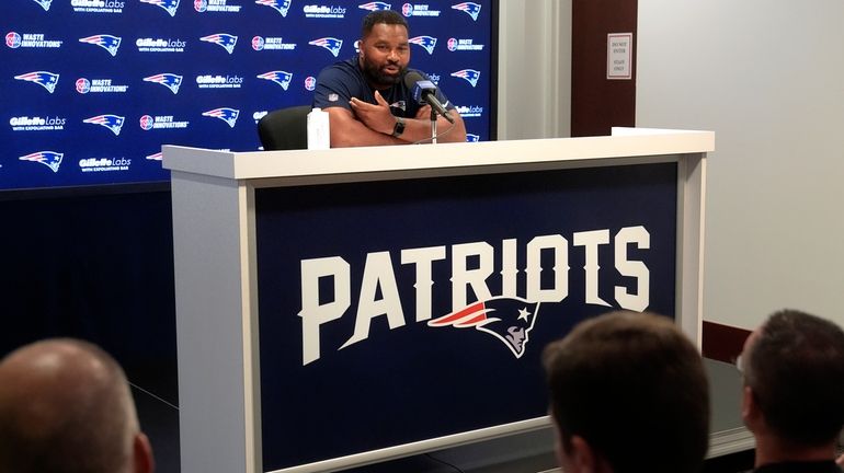 New England Patriots head coach Jerod Mayo faces reporters during...