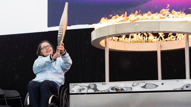 British Paralympian Helene Raynsford holds the Paralympic Torch during the...