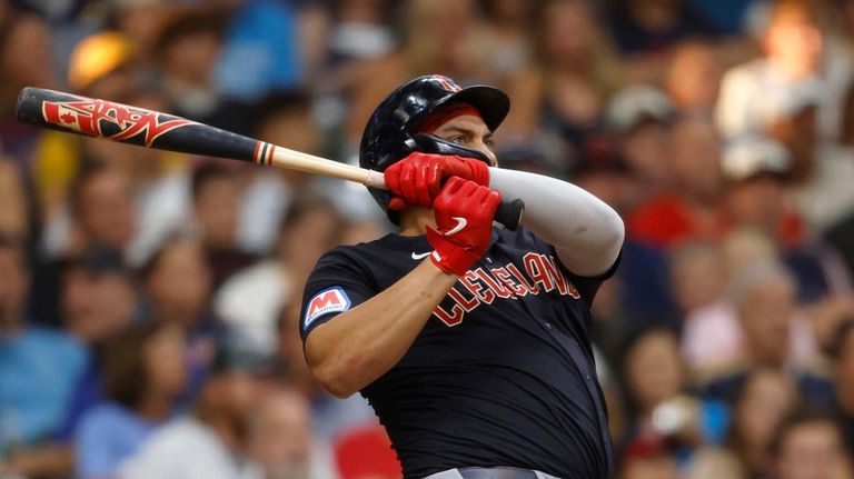 Cleveland Guardians' Josh Naylor watches his home run against the...