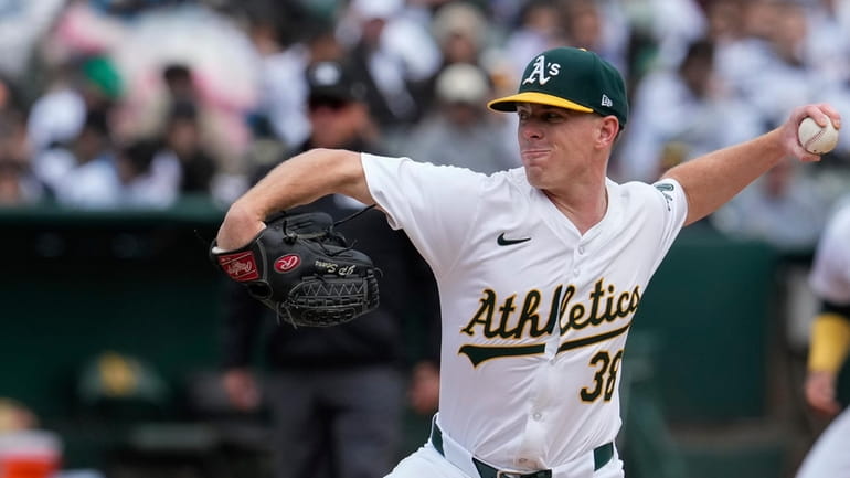 Oakland Athletics pitcher JP Sears throws to a Houston Astros...