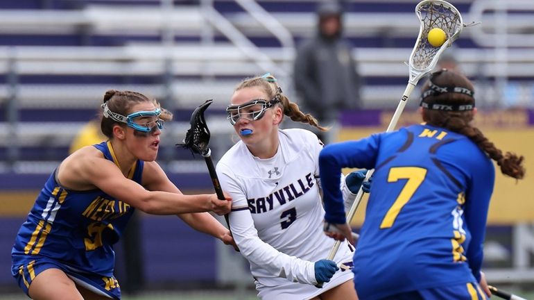 Sayville midfield Dylan McNamara drives towards the West Islip net,...