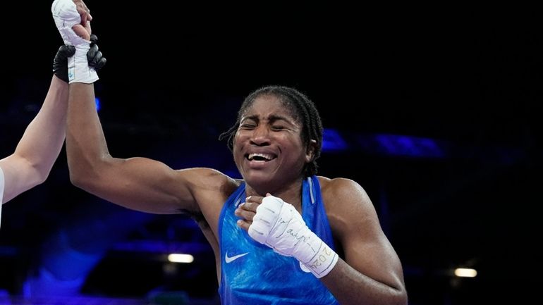 Refugee Olympic Team's Cindy Djankeu celebrates after defeating Canada's Tammara...