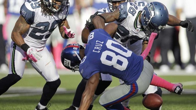 New York Giants wide receiver Victor Cruz fumbles the ball...