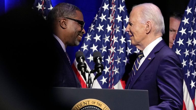 Derrick Johnson, president and CEO of the NAACP, left, greets...