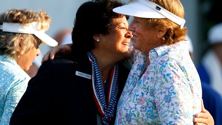 Nancy Lopez, front left, greets JoAnne Carner, right, during the...