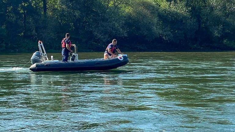 Rescue Service members search a Drina River near the town...