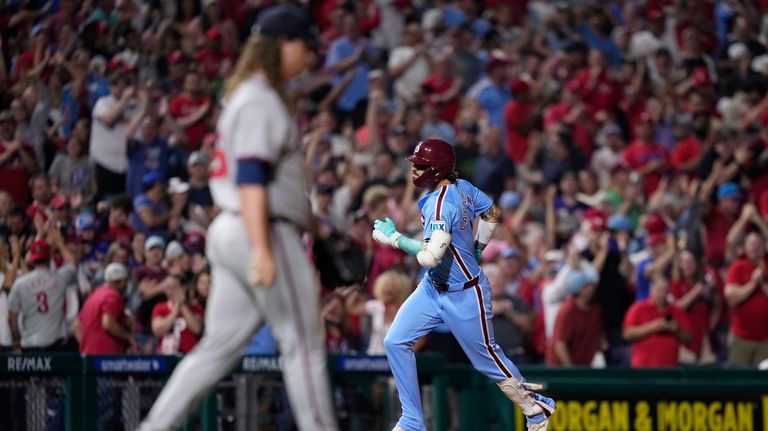 Philadelphia Phillies' Nick Castellanos, right, rounds the bases after hitting...