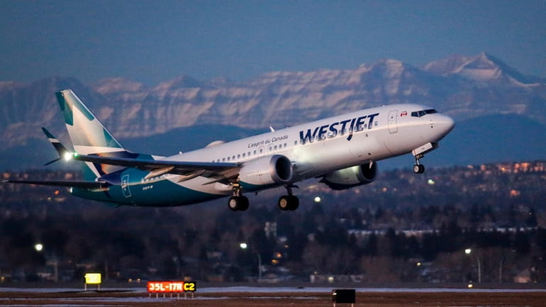 A wesJet airplane takes off in Calgary, Alta., Jan. 21,...