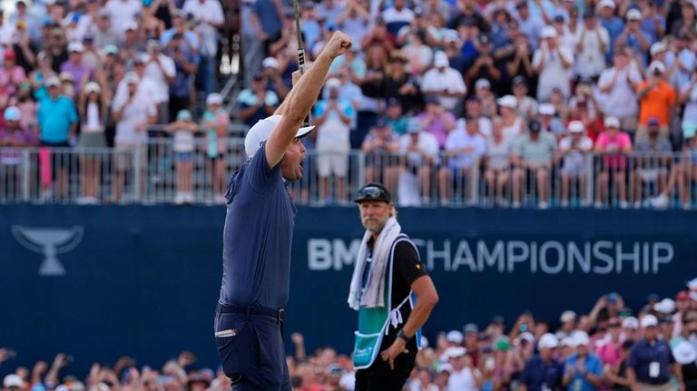 Keegan Bradley celebrates on the 18th green after winning the...