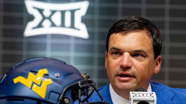 West Virginia head football coach Neal Brown answers questions from...