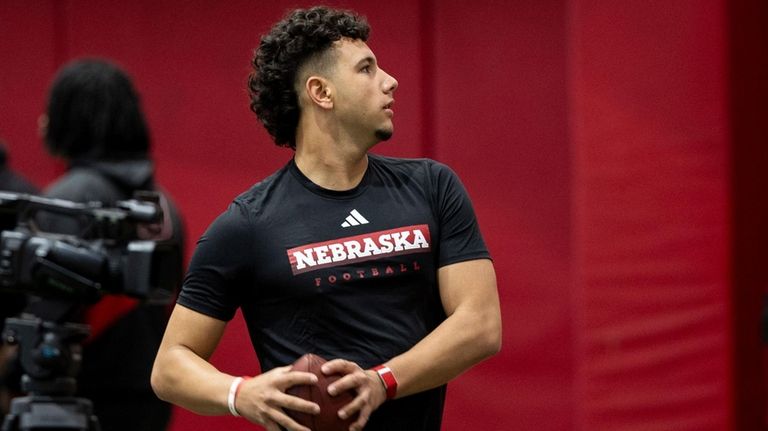 Nebraska quarterback Dylan Raiola throws passes for teammates during the...