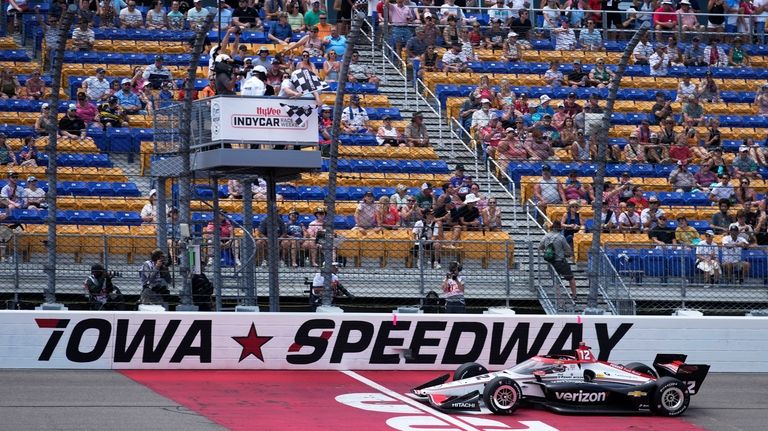 Will Power crosses the finish line as he wins an...