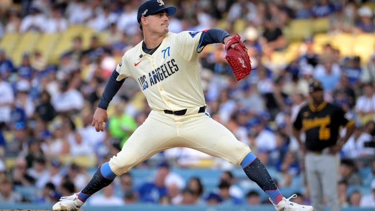 Los Angeles Dodgers' River Ryan delivers to the plate in...