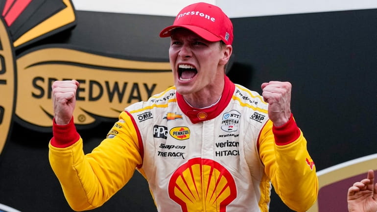 Josef Newgarden celebrates after winning the Indianapolis 500 auto race...