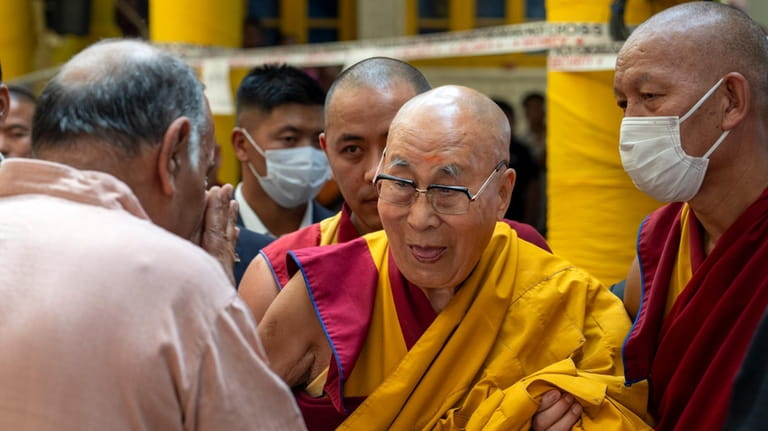 FILE- Tibetan spiritual leader the Dalai Lama greets a guest...
