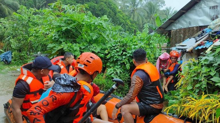 In this photo provided by the Philippine Coast Guard, rescuers...