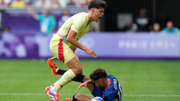 Spain'sPau Cubarsi, left, is fouled by Dominican Republic's Edison Azcona...