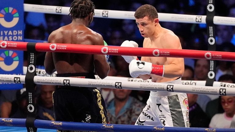 Terence Crawford, left, fights Israil Madrimov during a super welterweight...