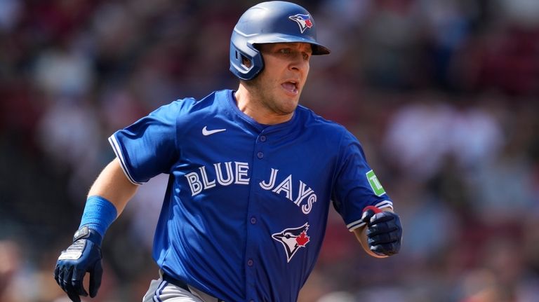 Toronto Blue Jays' Daulton Varsho dashes down the first base...