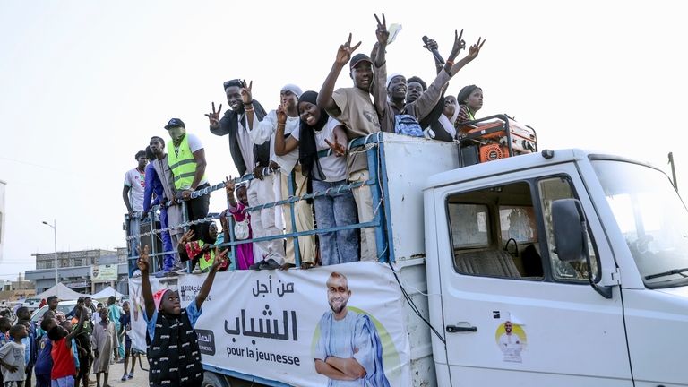 Youth take part in an electoral rally ahead of the...