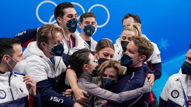 Madison Chock and Evan Bates, of the United States, reacts...