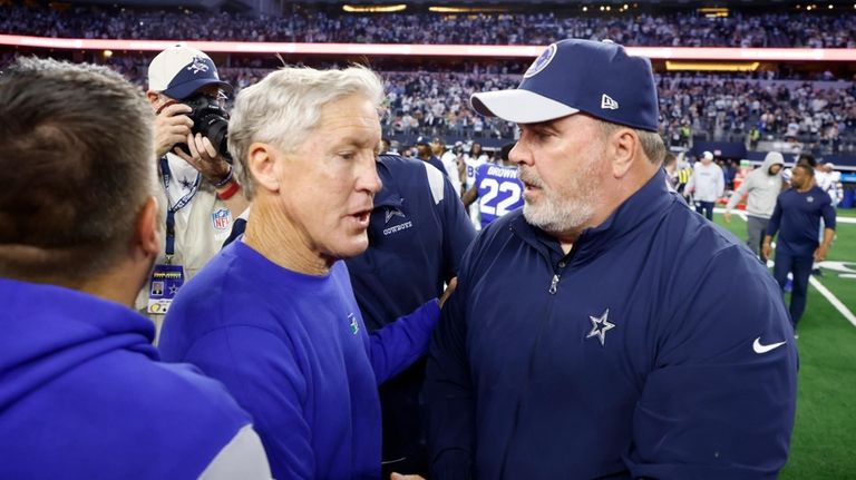 Seattle Seahawks head coach Pete Carroll, left, and Dallas Cowboys...