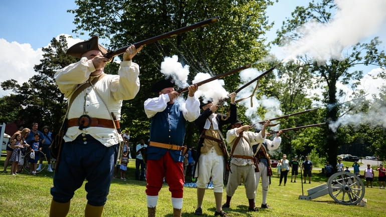 A reenactment of the 1776 reading of the Declaration of...