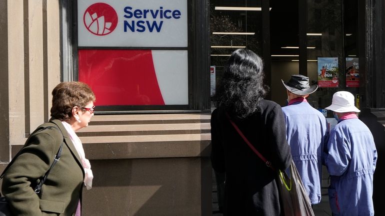 People walk in to a Services New South Wales office...