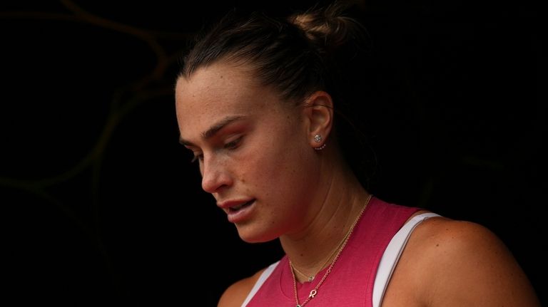 Aryna Sabalenka, of Belarus, returns to the court after a...