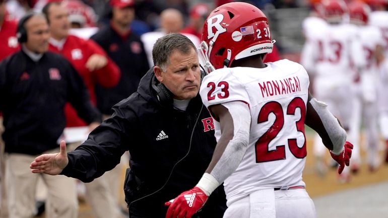 Rutgers head coach Greg Schiano, left, congratulates running back Kyle...