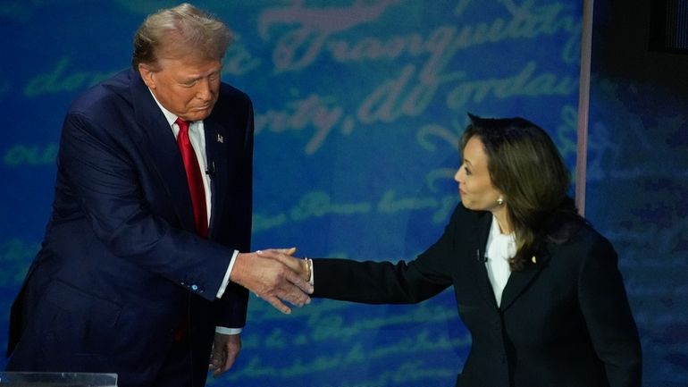 Republican presidential nominee former President Donald Trump shakes hands with...