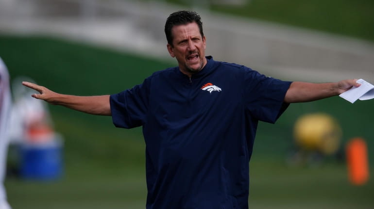 Then-Broncos quarterbacks coach Greg Knapp takes part in drills during training...