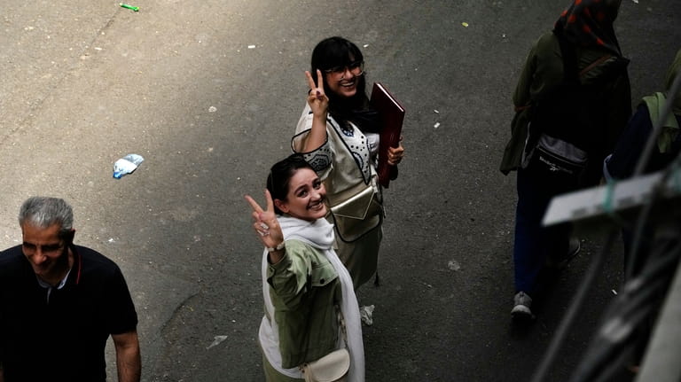 Iranian women without wearing their mandatory Islamic headscarf flash the...
