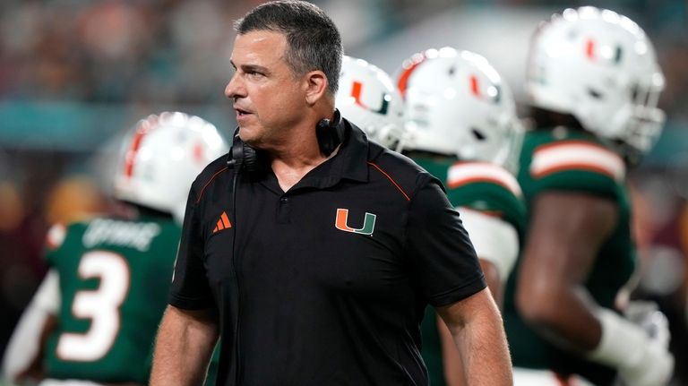 Miami coach Mario Cristobal watches during the first half of...