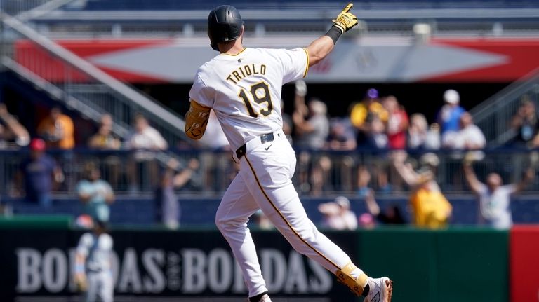 Pittsburgh Pirates' Jared Triolo rounds the bases after hitting a...