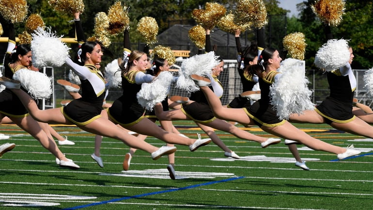 The Commack High School kickline entertains during halftime of a...