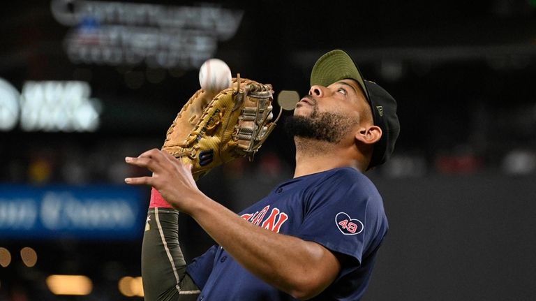 Boston Red Sox first baseman Dominic Smith catches a foul...