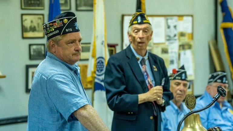 Nassau County American Legion Commander Sean Hood speaks to other...