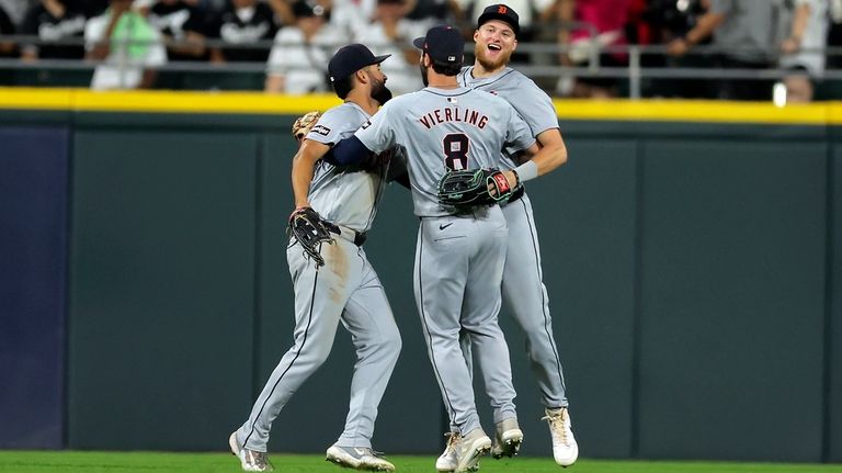 Detroit Tigers' Parker Meadows, right, Matt Vierling (8) and Riley...