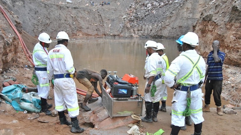 Mine workers are seen during a rescue mission in Chingola,...