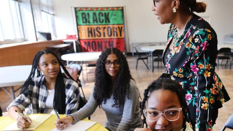 Uniondale schools Superintendent Monique Darrisaw-Akil speaks with club members, from left, Zahara...