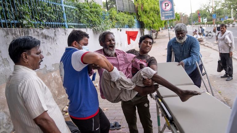 Baleshwar, who does not use a surname, is lifted onto...