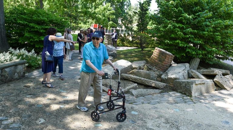 Holocaust survivor Meir Usherovitz, of St. James, walks in the Anne...