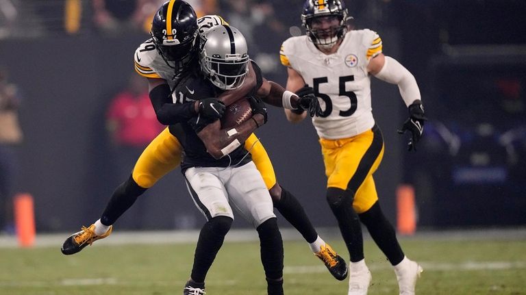 Las Vegas Raiders wide receiver Davante Adams is tackled Pittsburgh...