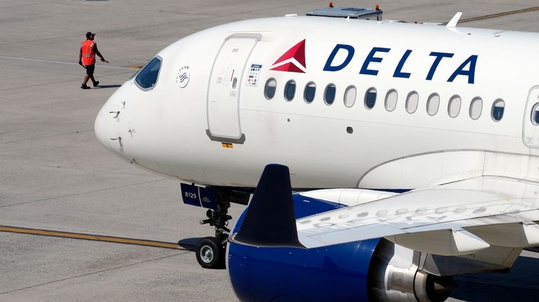 A Delta Air Lines jet leaves the gate, July 19,...