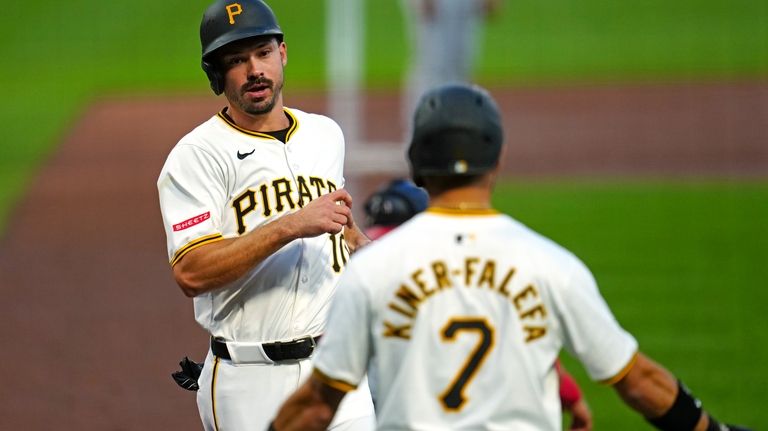 Pittsburgh Pirates' Bryan Reynolds, left, and Isiah Kiner-Falefa (7) score...