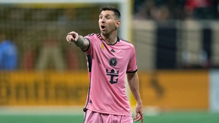 Inter Miami forward Lionel Messi talks to a teammate during...