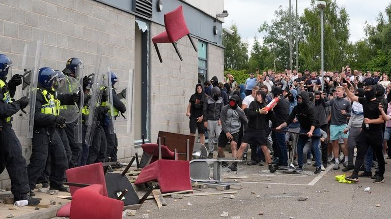 A chair is thrown at police officers as trouble flares...