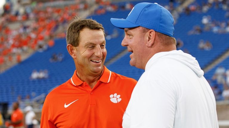 Clemson head coach Dabo Swinney, left, speaks with Duke head...